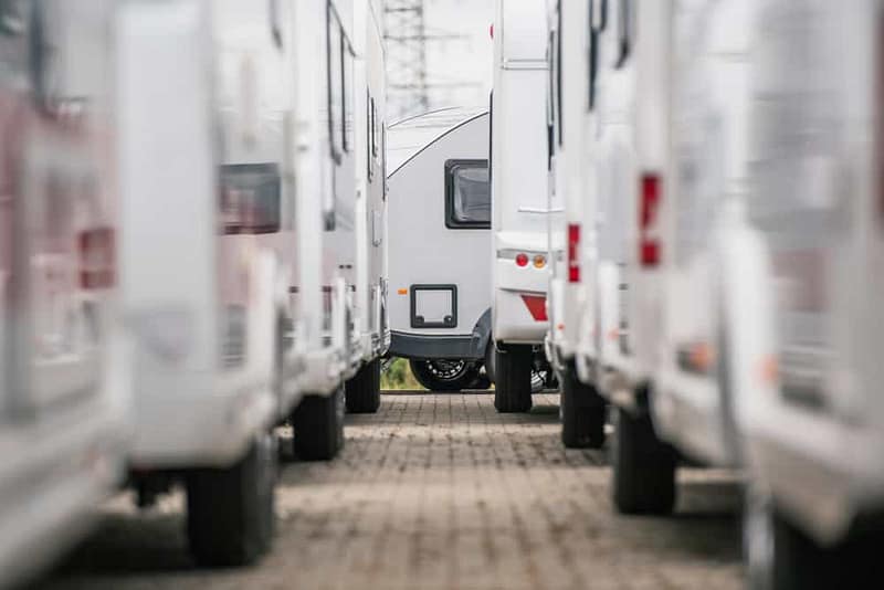 In June, the RVIA welcomed new members with a row of white RVs parked in a parking lot.
