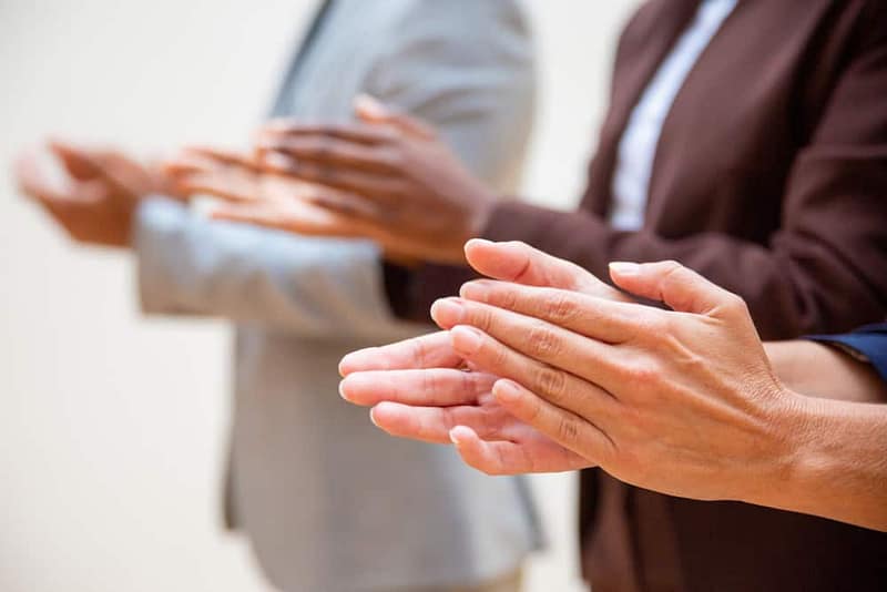 A group of executive directors clapping their hands at the Virginia Campground Association.