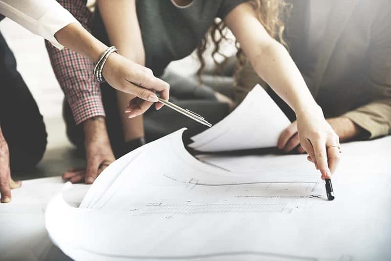 A group of people working on blueprints for a Holiday Park in Lincolnshire, seeking approval.