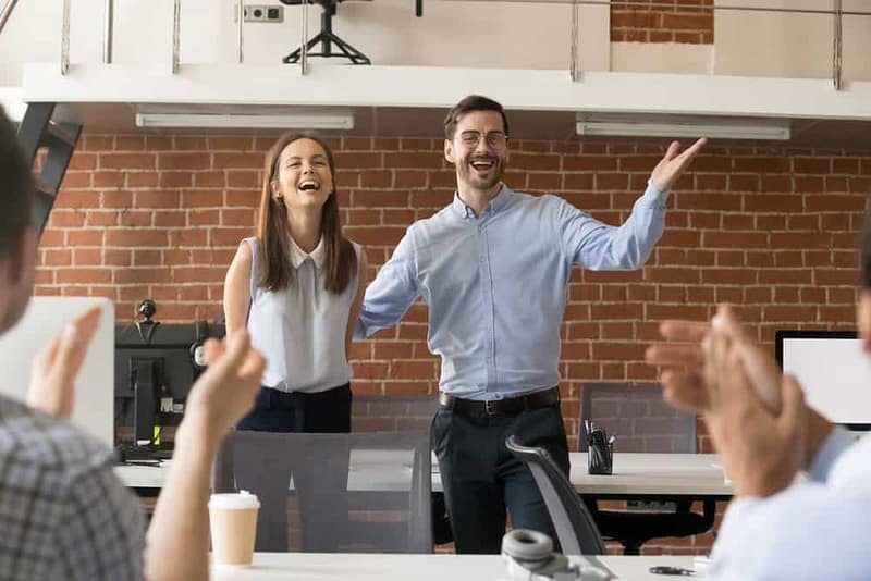 RVIA Welcomes new members by having a group of people clapping in an office.