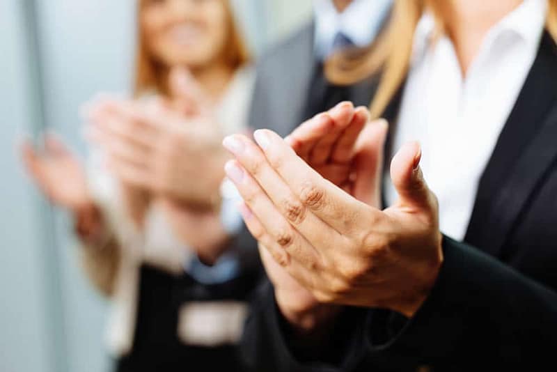 The Board of Directors, consisting of business people, enthusiastically applaud each other during the RVIA meeting.