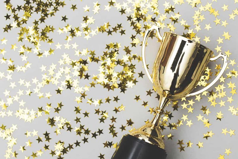 A gold trophy adorned with gold stars, awarded based on the CCRVC criteria for the COHCE Award.