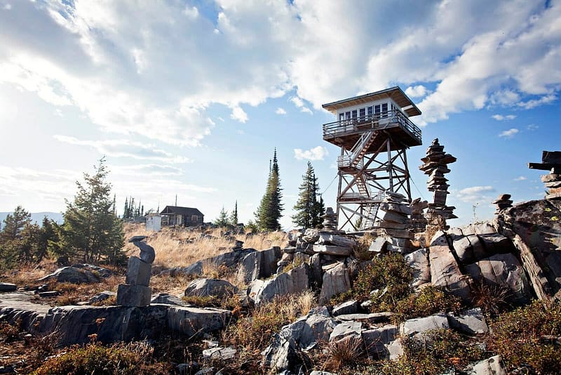 America's Most Coveted Destinations - A fire tower sits on top of a rocky mountain.