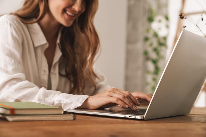 A woman using the Interactive Tool on her laptop to calculate revenue.