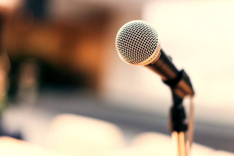 A close up of a microphone in front of a table as the Veteran Service Department Foreman discusses strategies to improve efficiency.