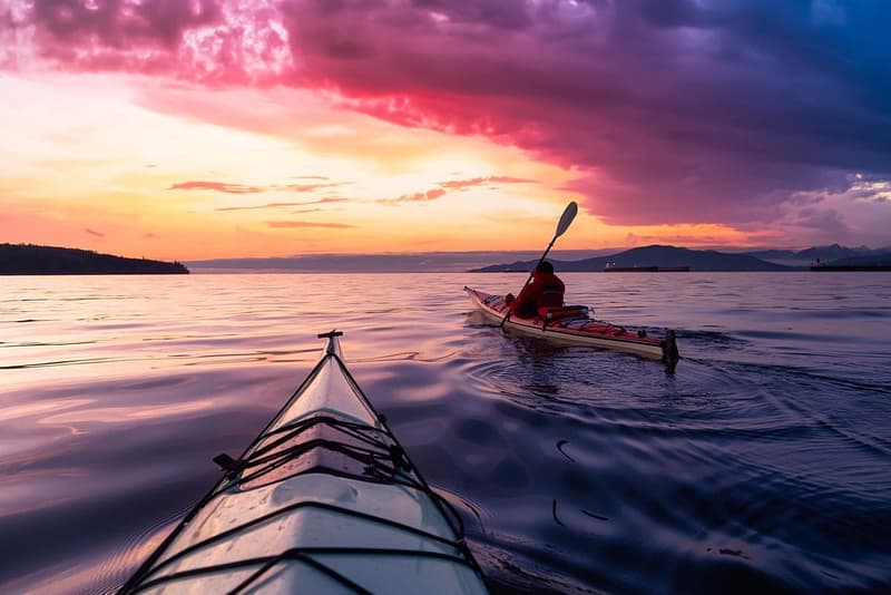 In 2023, international tourists are enjoying Canada's tourism spending while paddling kayaks in the water.