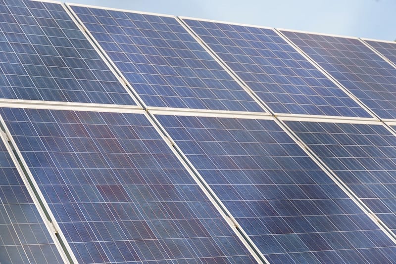 A photo of solar panels transforming a former golf course into a sustainable energy source, captured by US Light Energy.