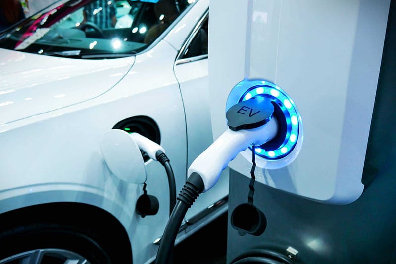 A white car is being charged at an EV Charging station in Virginia.