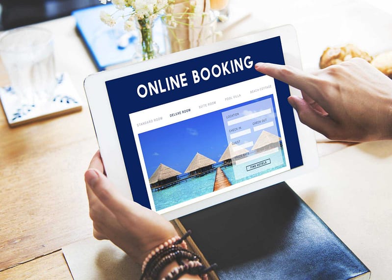 A person holding a tablet using the online booking system for reservations at Gulpha Gorge Campground.