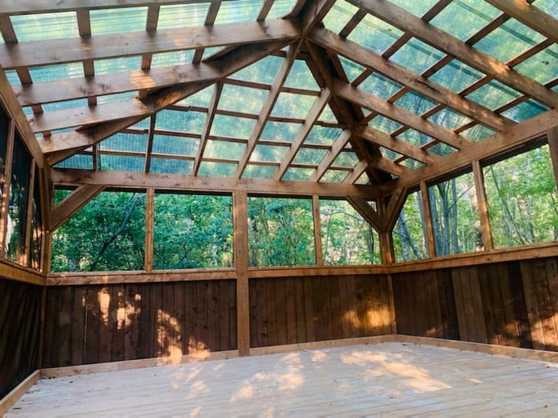 A tranquil screened in porch nestled in the woods at Creekside RNR Glamping Resort.