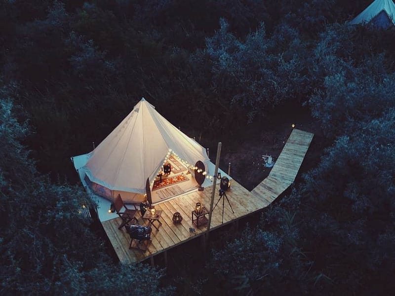 An aerial view of a glamping structure in the woods, designed by Glampitect for North America's 2023.