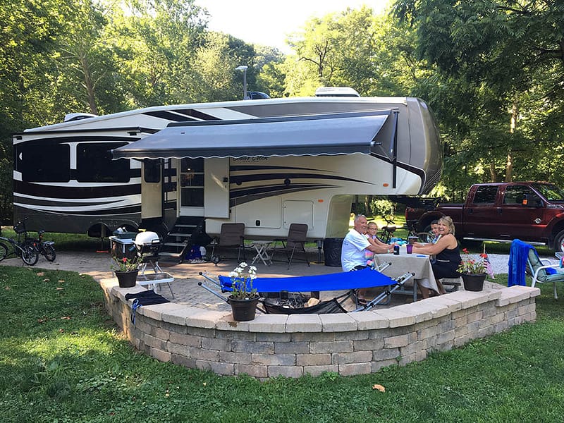 A large RV parked in a wooded area at Austin Lake RV Park.