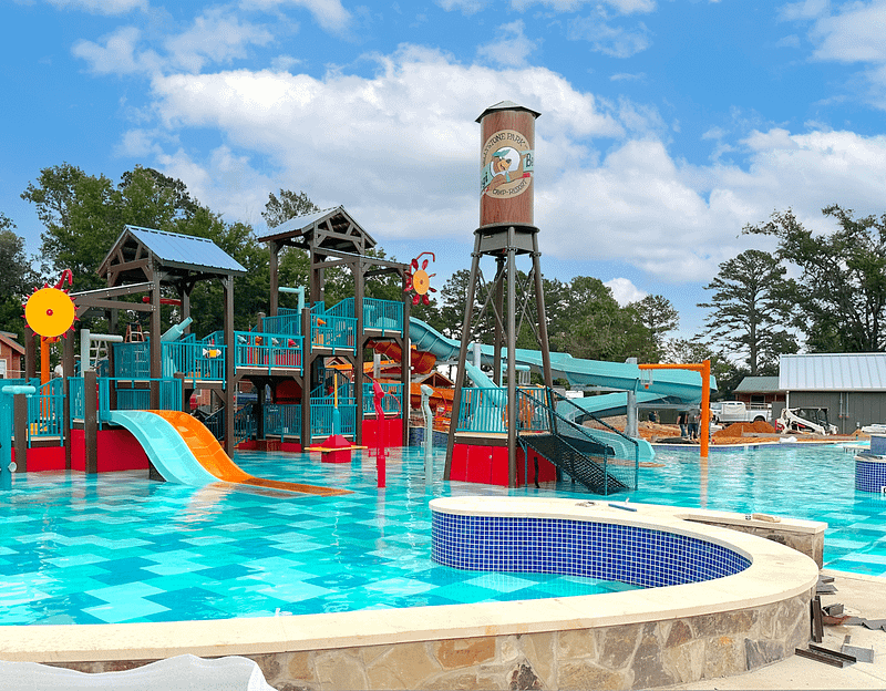 Yogi Bear's Jellystone Park in Tyler, Texas offers an exhilarating water park experience with a thrilling slide and various water attractions.