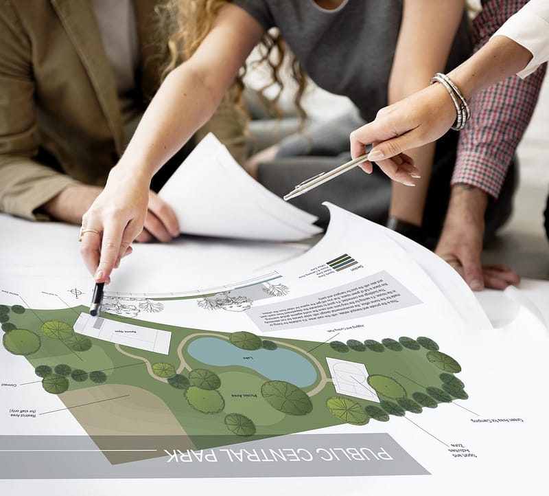A group of people working on a plan for a garden.