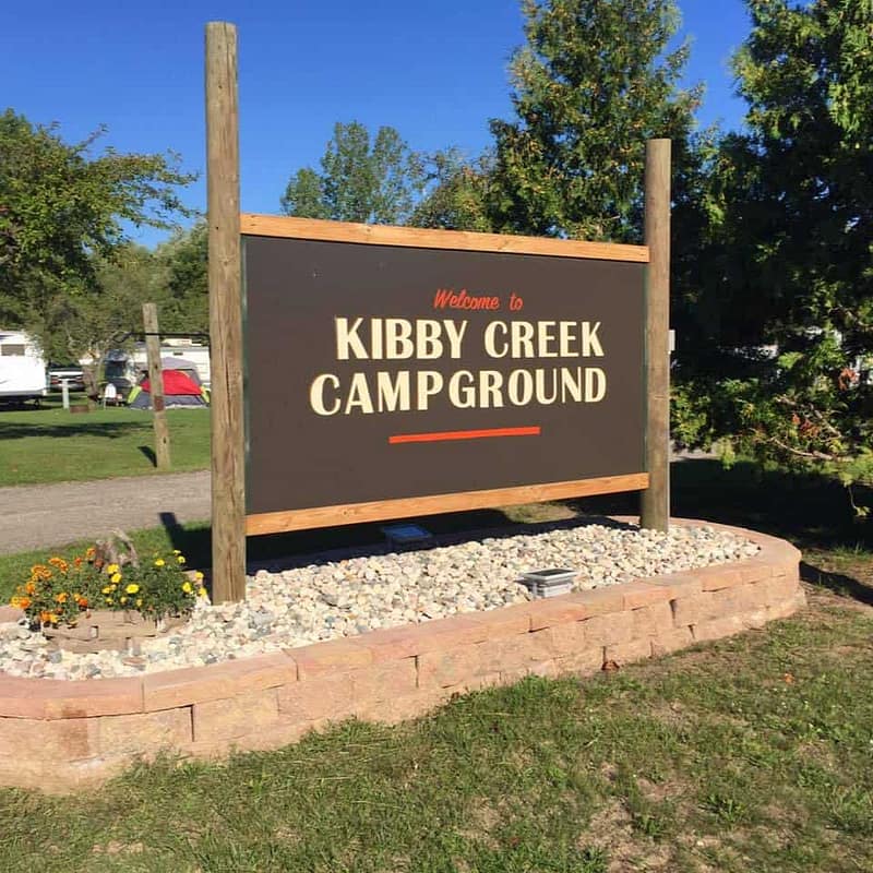 A sign showcasing the offerings at Kibby Creek Campground with information about the available sites.
