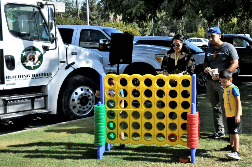 The CA County Sheriff's Youth Services RV hosts a group of people playing a game of connect the dots.