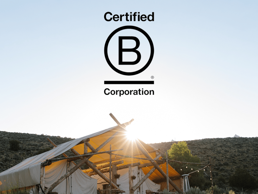 A sustainable tent adorned with the words "Certified B Corp" by Collective Retreats.