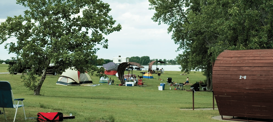 A group of tents in a grassy area with trees at El Dorado State Park.