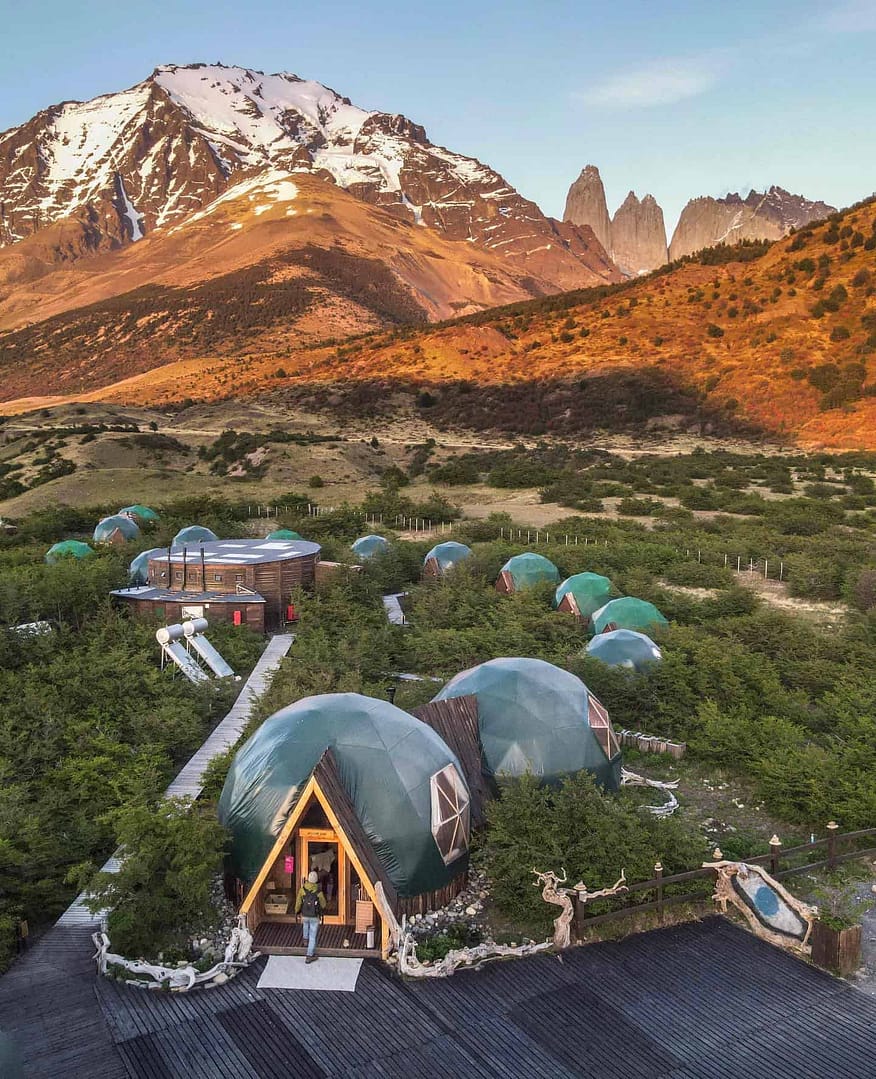 An eco-friendly group of geodesic domes nestled against the backdrop of majestic mountains, creating the perfect glamping experience.