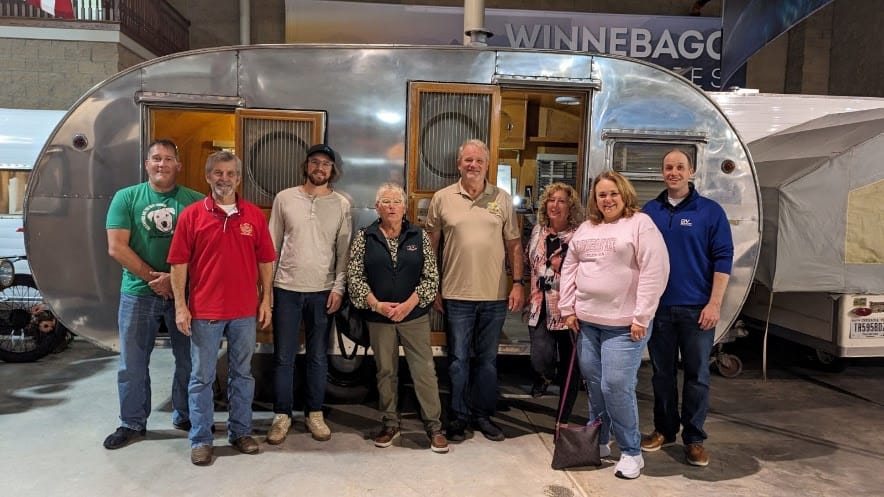 NJCOA members standing in front of an airstream trailer at the RV manufacturing site in Elkhart.