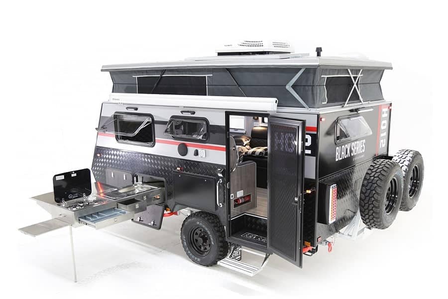 An Australian off-road camper trailer that doubles as a glamping machine, complete with a kitchen and a cozy bed.