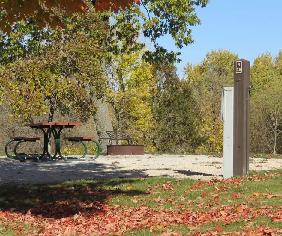 A picnic table in a park with fall leaves, located in Linn County Conservation.