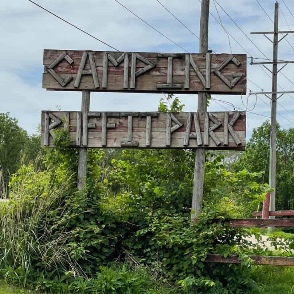 A newly renovated wooden sign that reads Ruffit Park Campground.