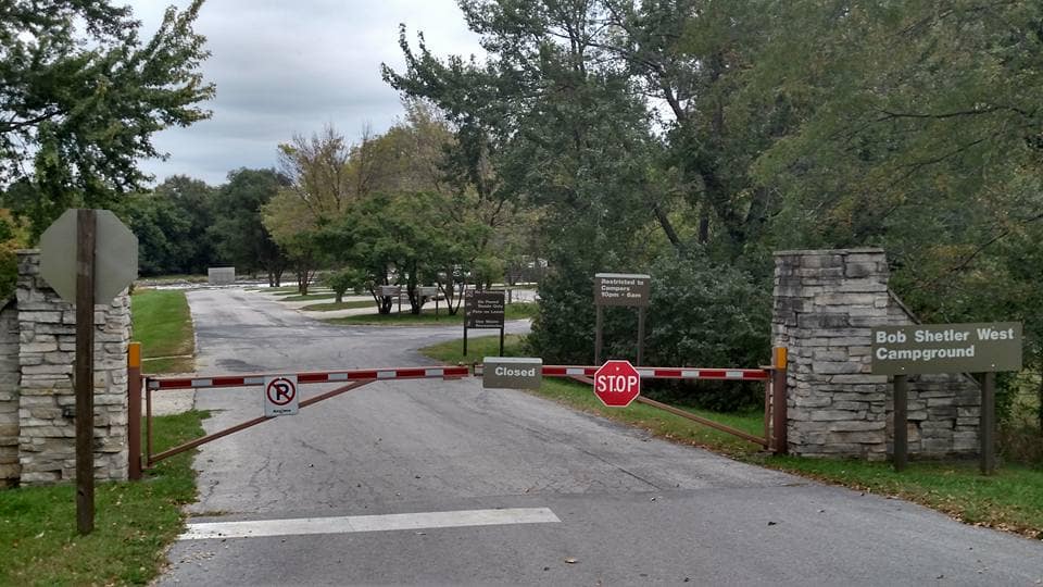 A road with a gate in the middle of it, leading to Saylorville Lake.