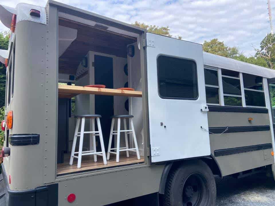 An RV makeover of a school bus with a kitchen inside.