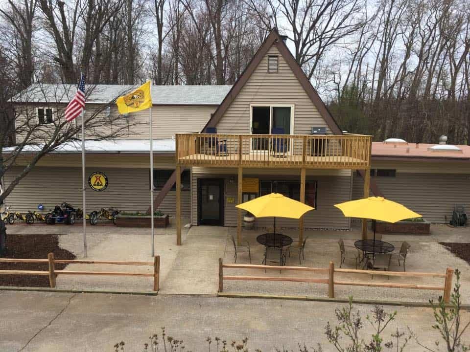 A St. Joseph KOA Holiday building with a yellow umbrella on top of it, situated in Coloma during camping season.