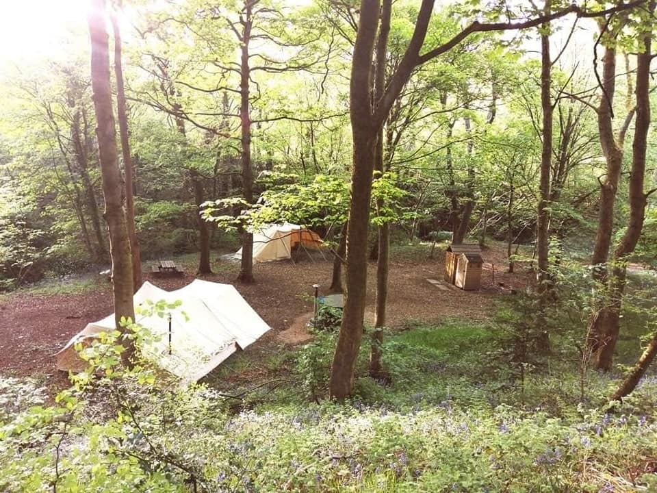 Enchanted Woodland Adventures offers a collection of tents in a secluded wooded area, perfect for Secret Wood Glamping. Located in the picturesque Peak District, indulge in a unique camping experience surrounded