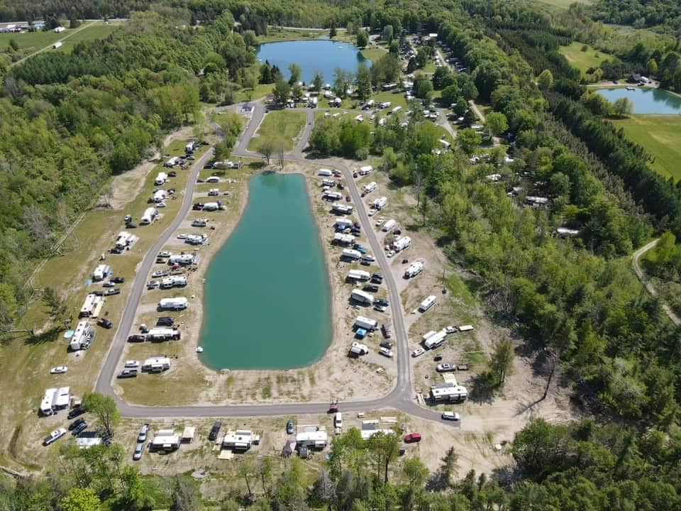 Discover Dream Lake Campground offers a breathtaking aerial view of an RV park surrounded by a serene lake.