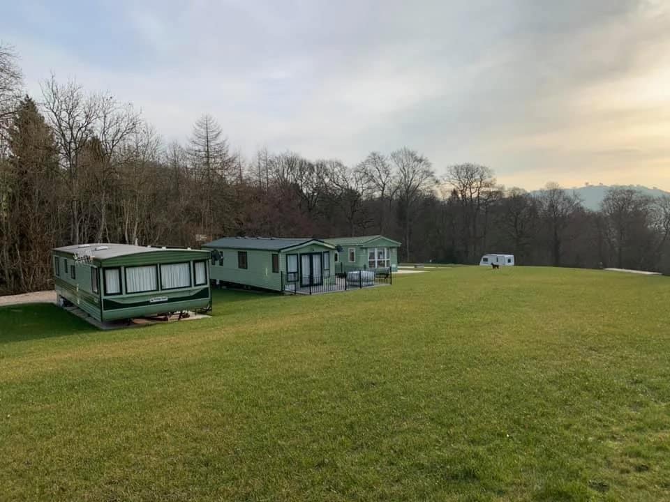 Two mobile homes parked on a grassy field at Llety’r Eos Caravan Park in Llanfyllin.