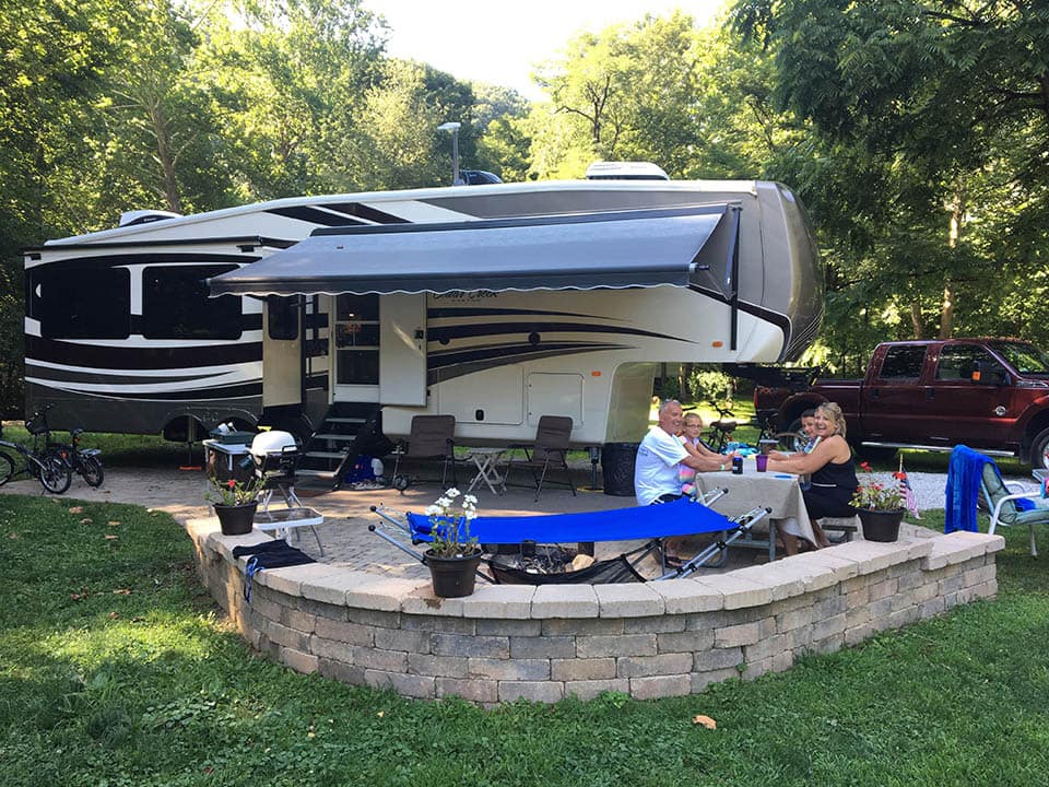 A large RV parked in a wooded area at Austin Lake RV Park.