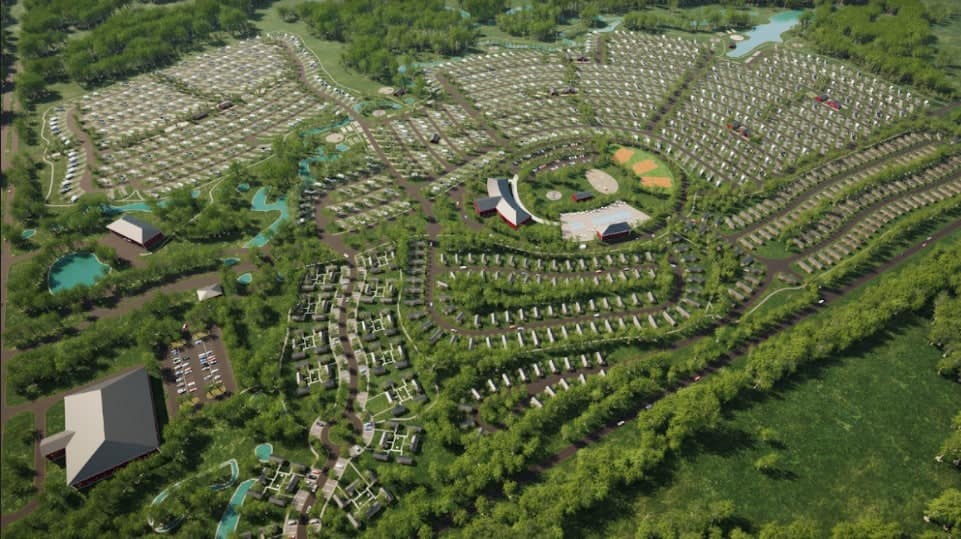 An aerial view of a park filled with an abundance of trees, attracting numerous visitors.
