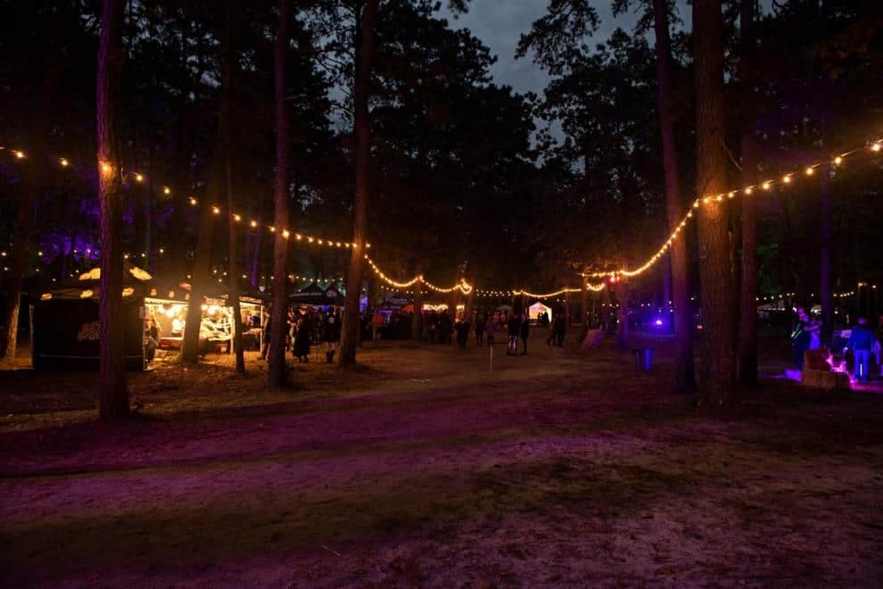 A witch-tastic festival in the New Jersey campground, illuminated by string lights.